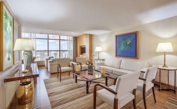 a living room with a couch and chairs