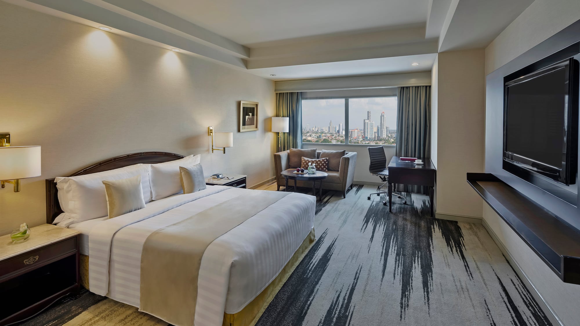 a hotel room with a large bed and a desk