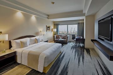 a hotel room with a large bed and a desk