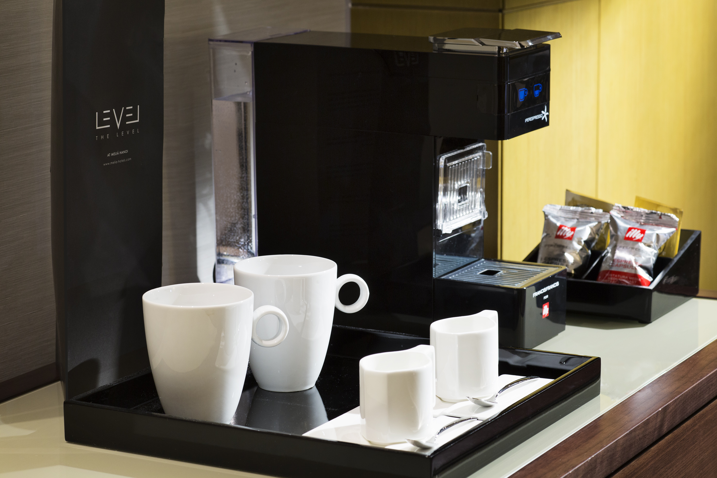 a coffee machine with cups on a tray
