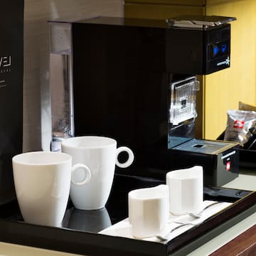 a coffee machine with cups on a tray