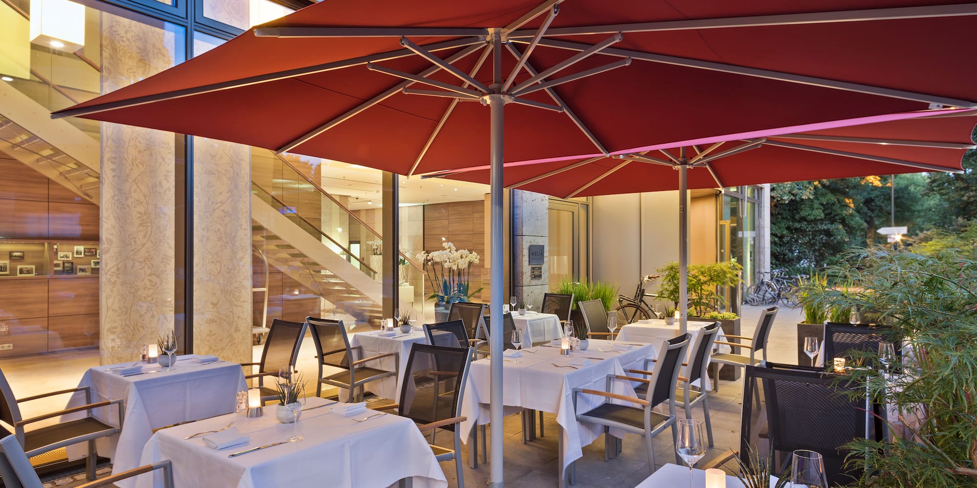 tables and chairs under an umbrella
