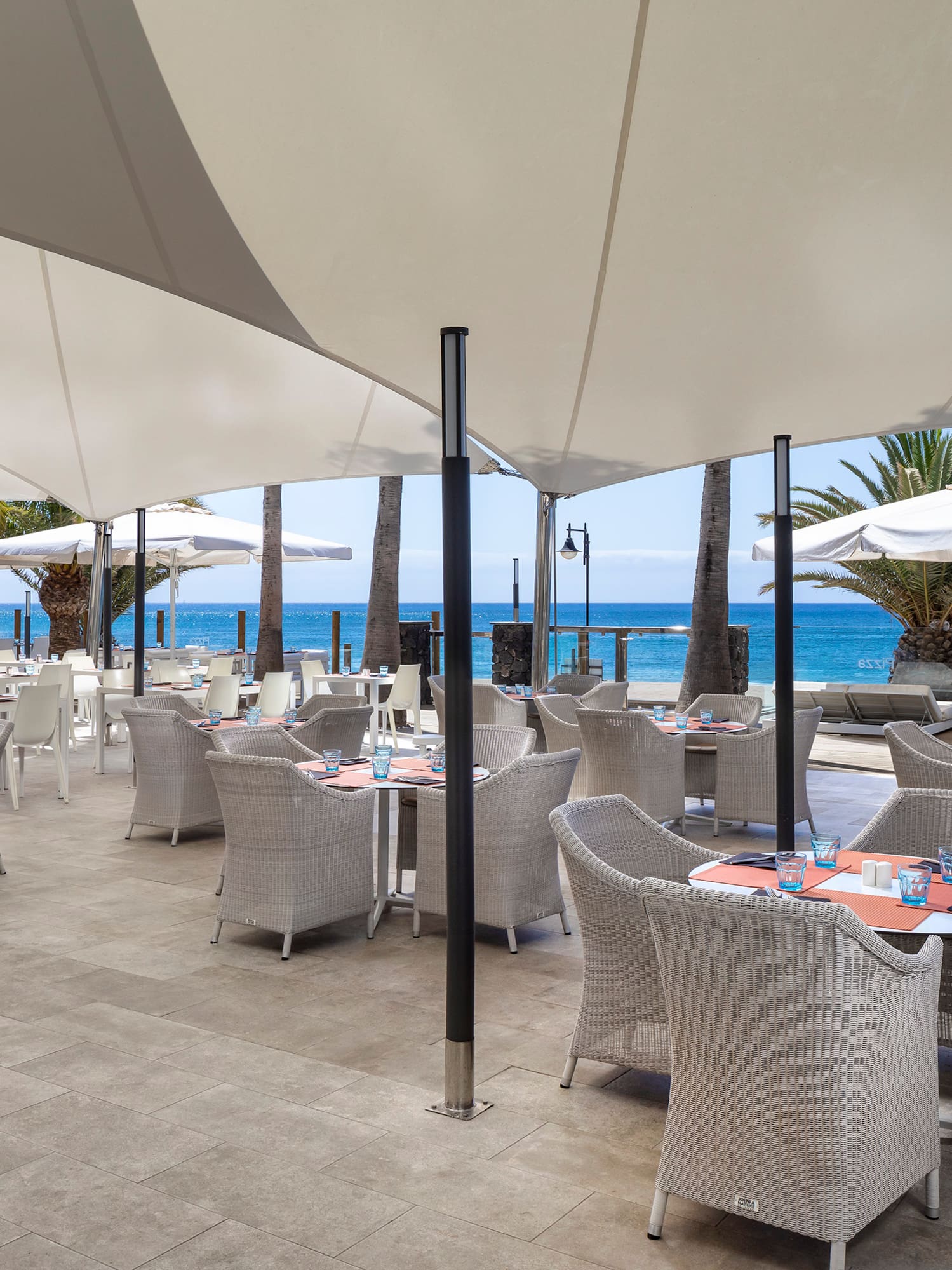 a restaurant with tables and umbrellas