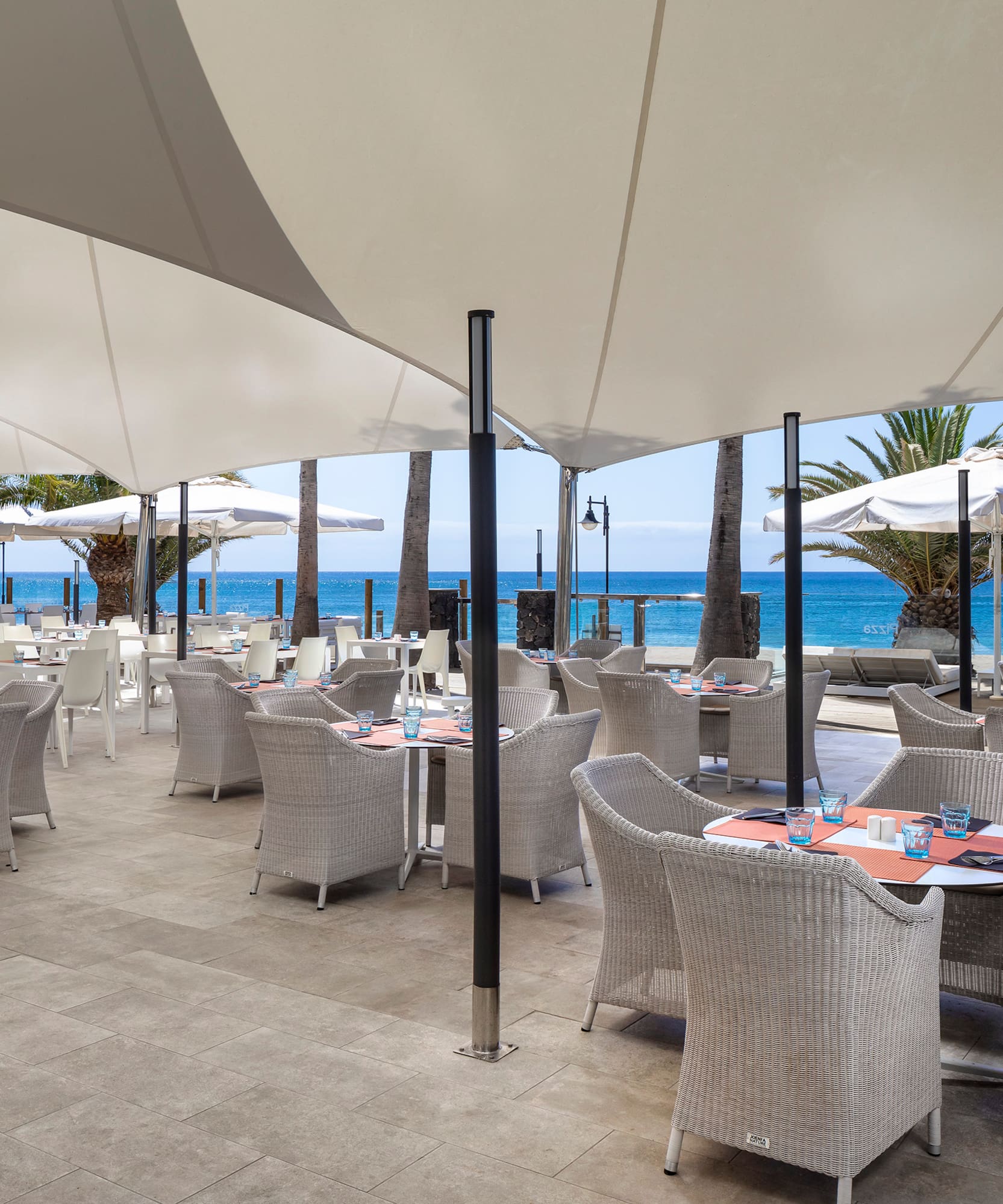 a restaurant with tables and umbrellas