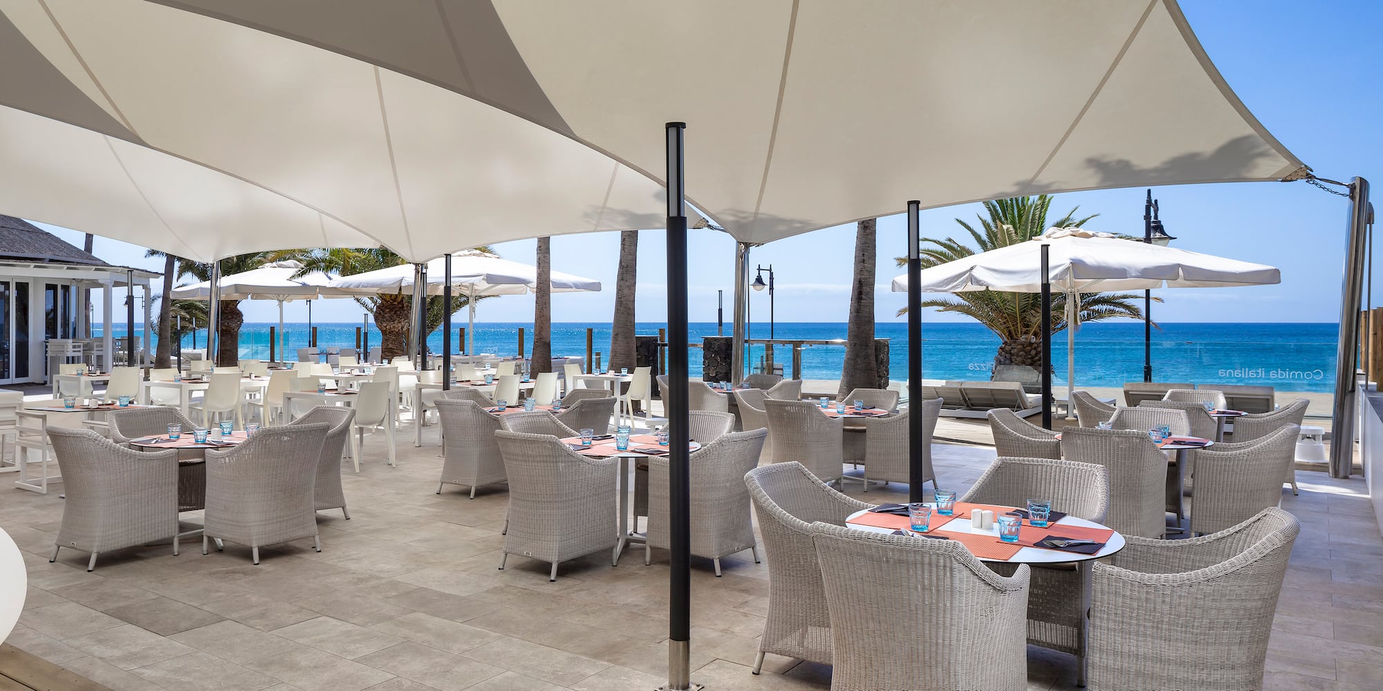 a restaurant with tables and umbrellas