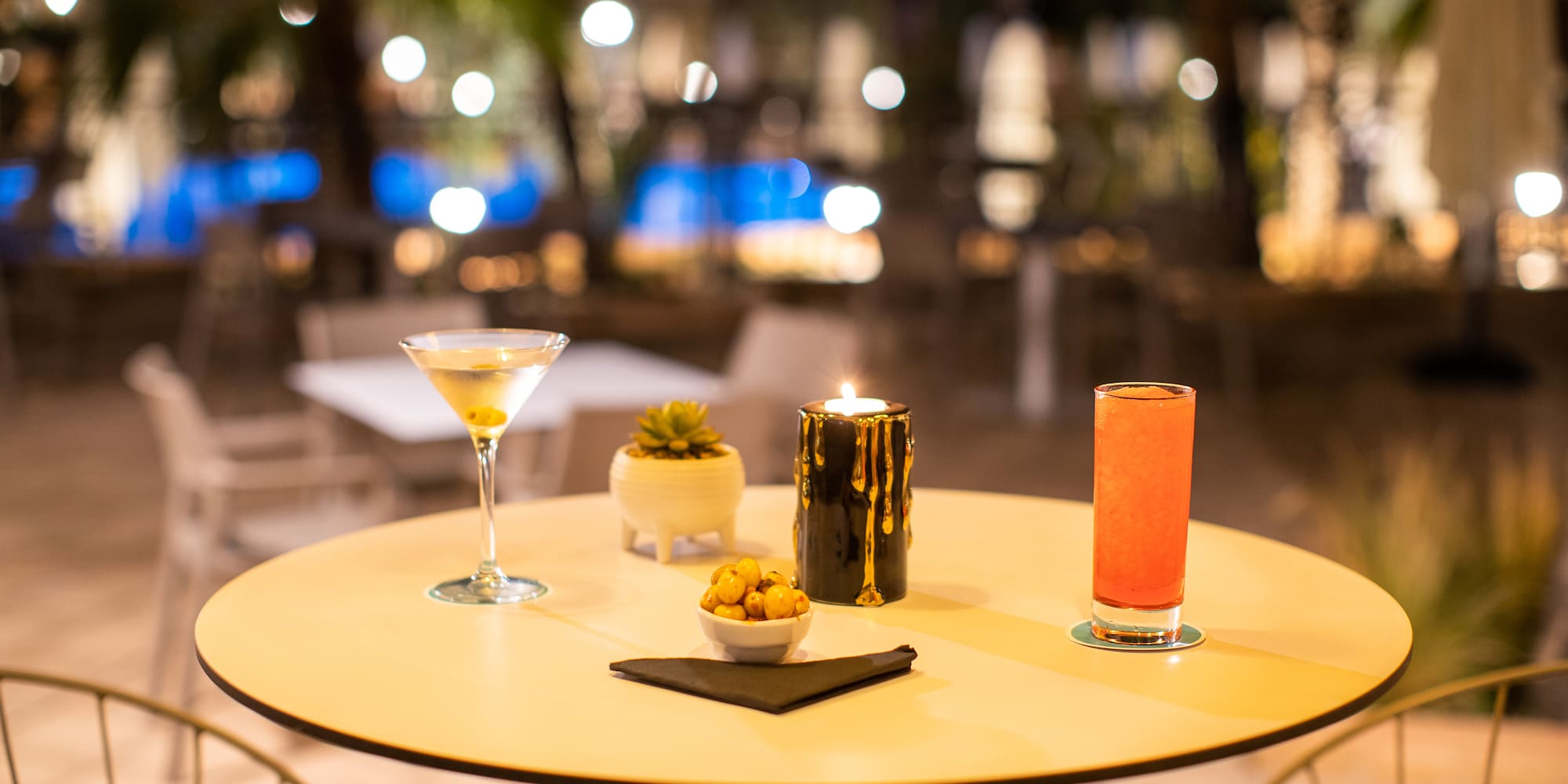 a table with drinks and candles on it