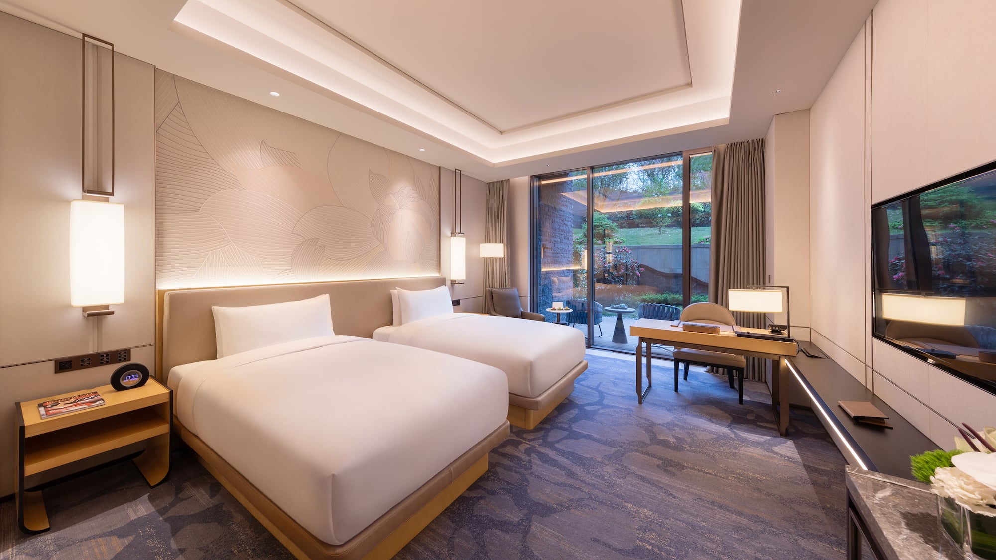 a room with two beds and a desk