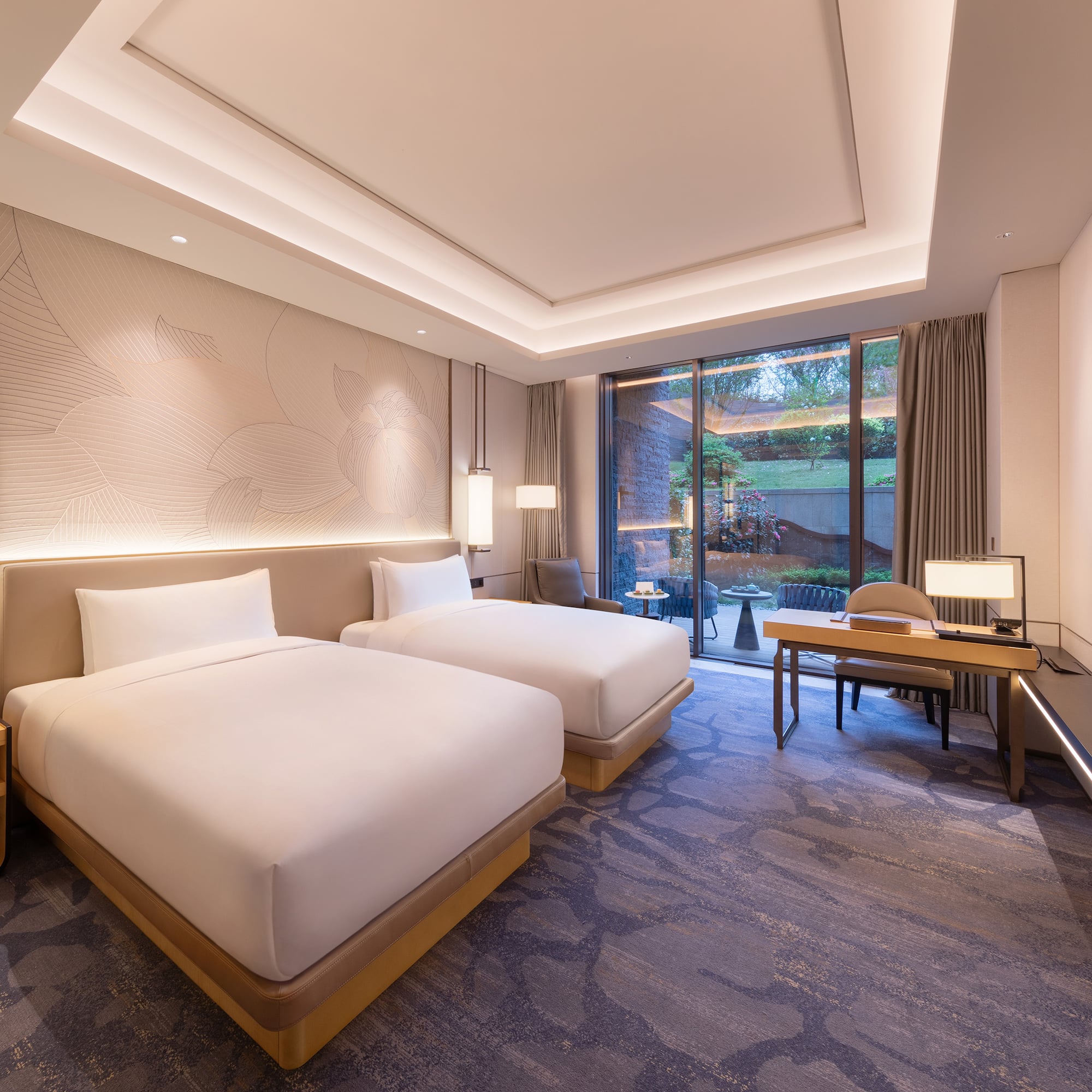 a room with two beds and a desk