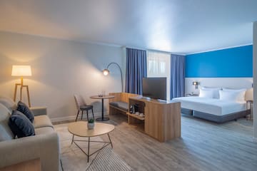 a room with a bed and a tv