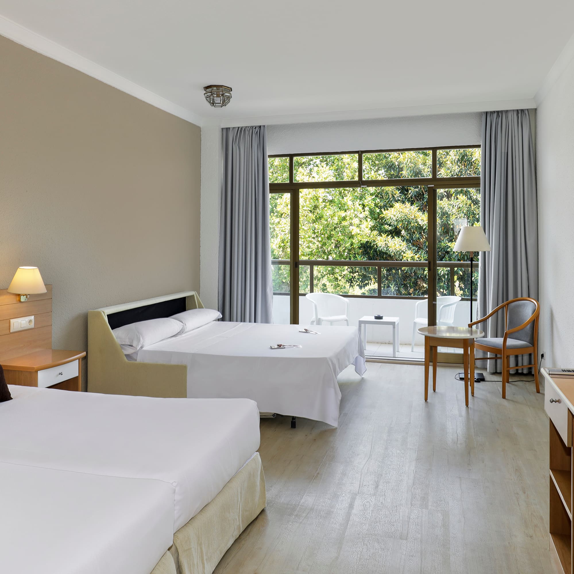 a room with two beds and a table