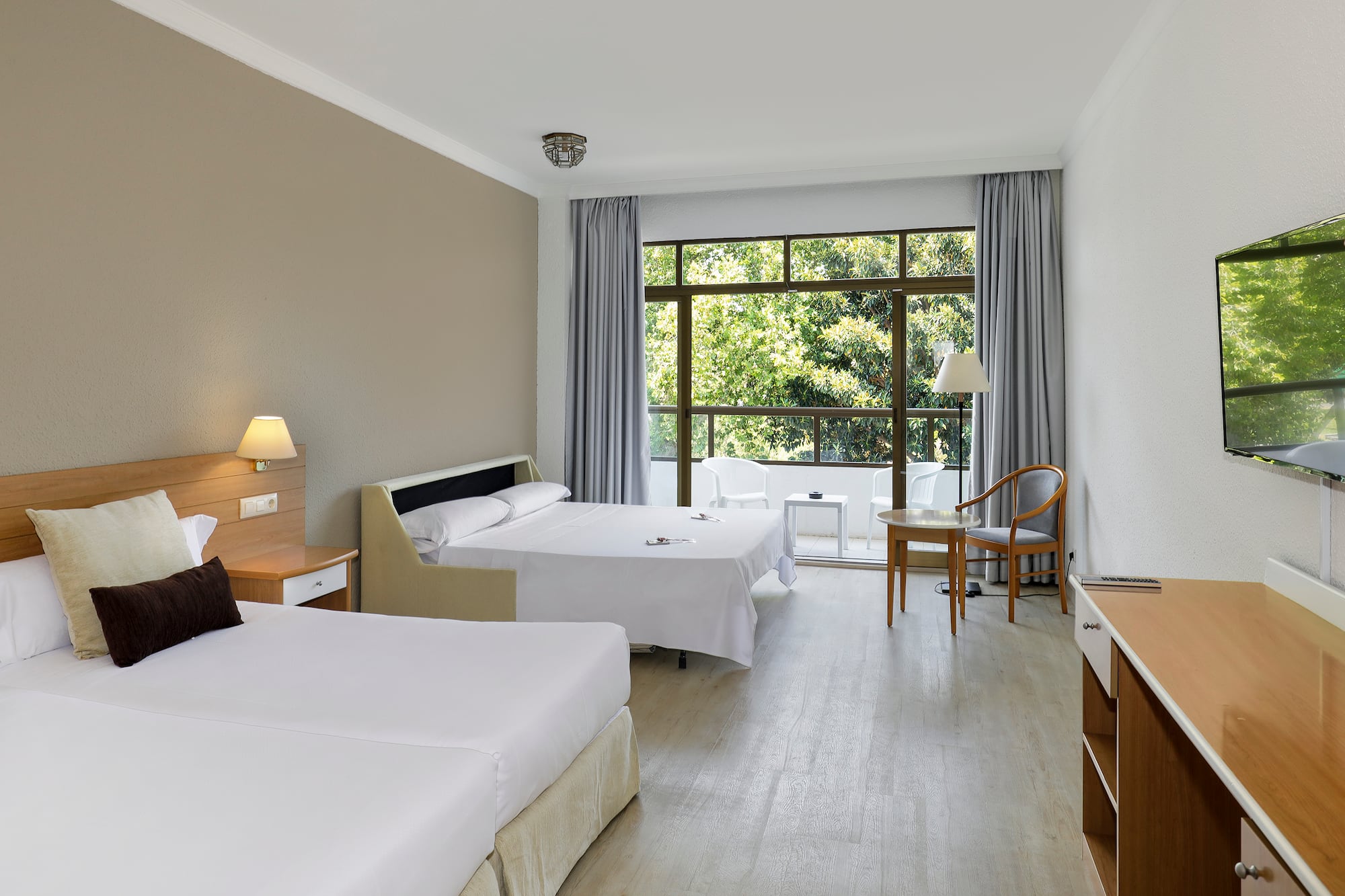 a room with two beds and a table