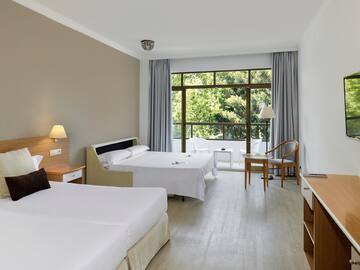 a room with two beds and a table