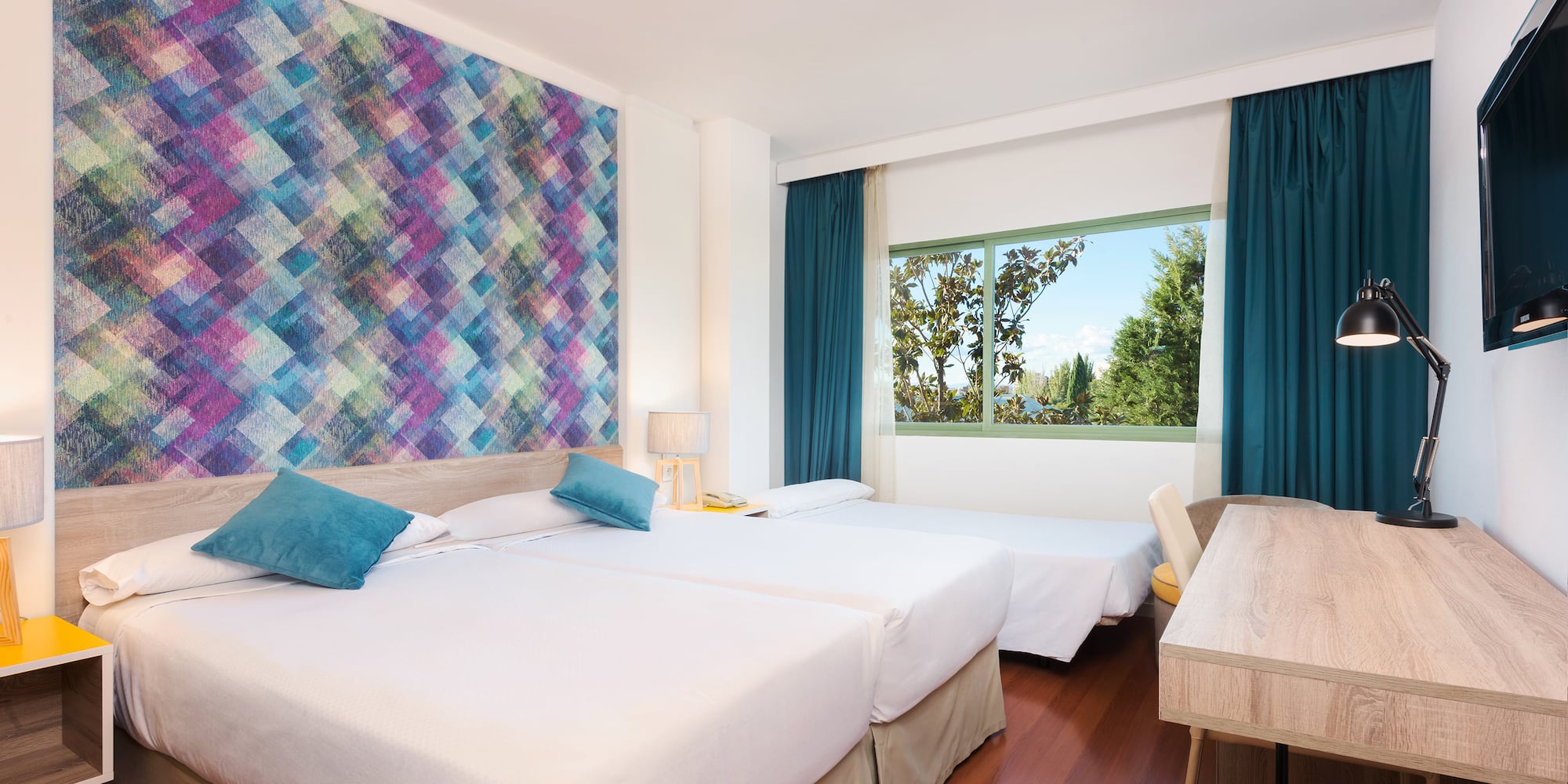 a room with two beds and a table