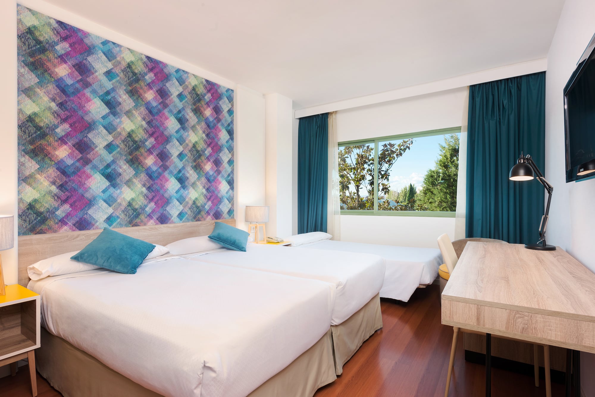 a room with two beds and a table