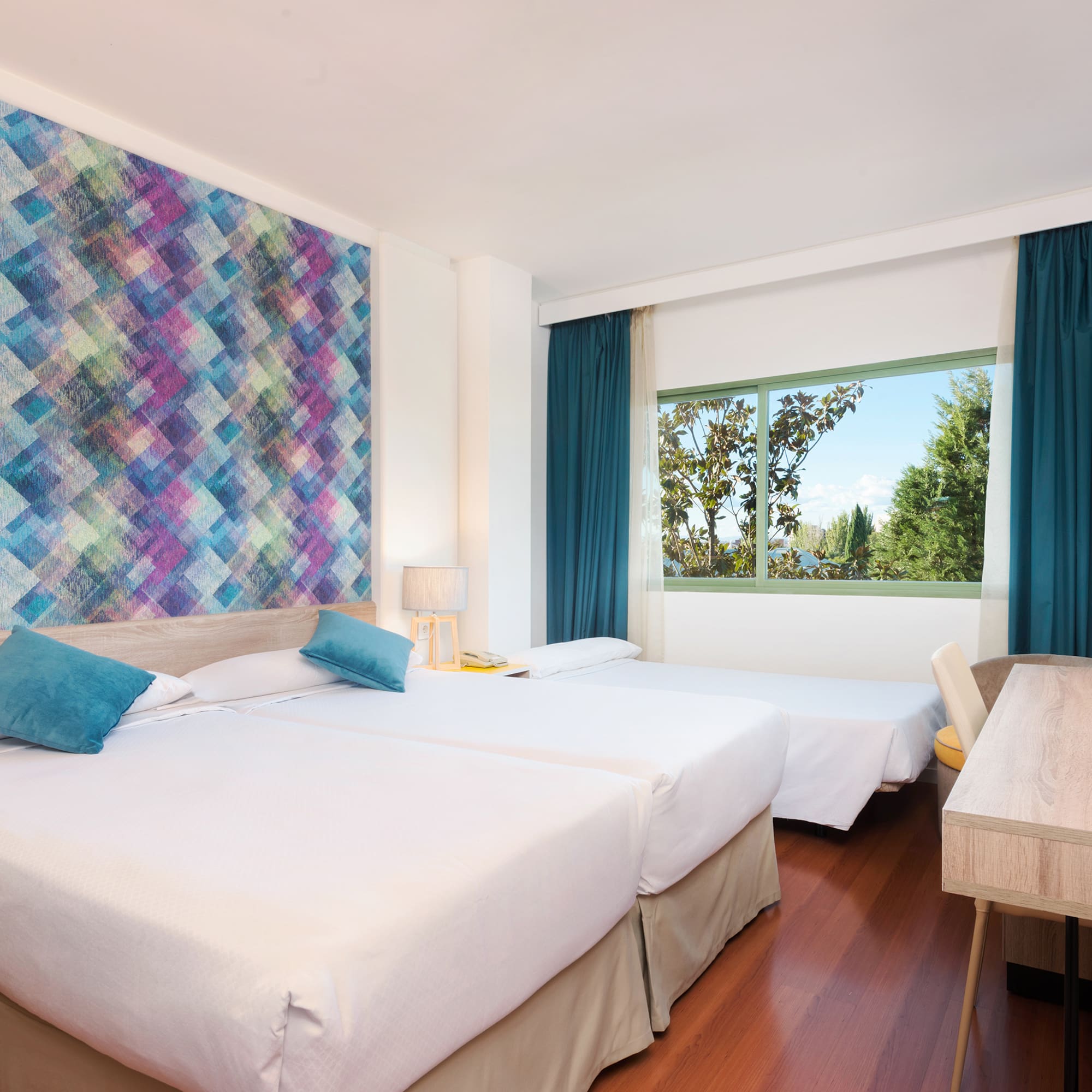 a room with two beds and a table