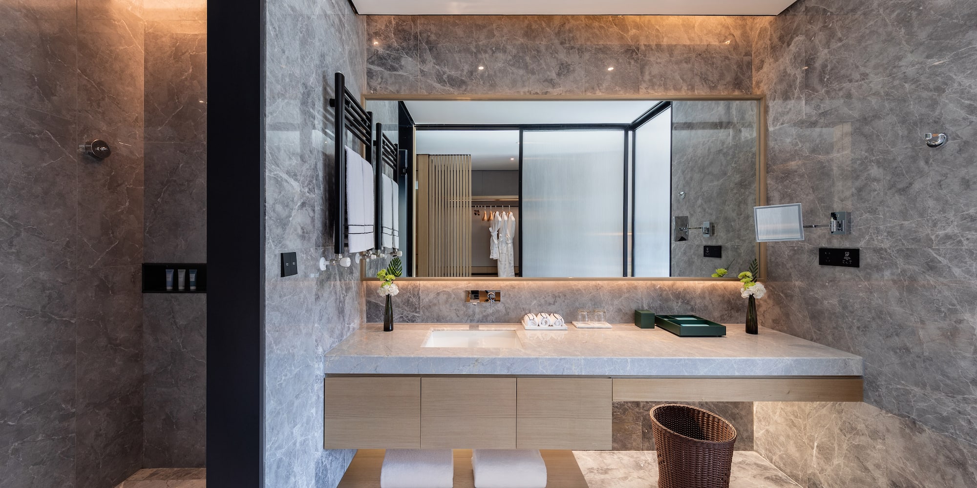 a bathroom with a marble countertop and a large mirror