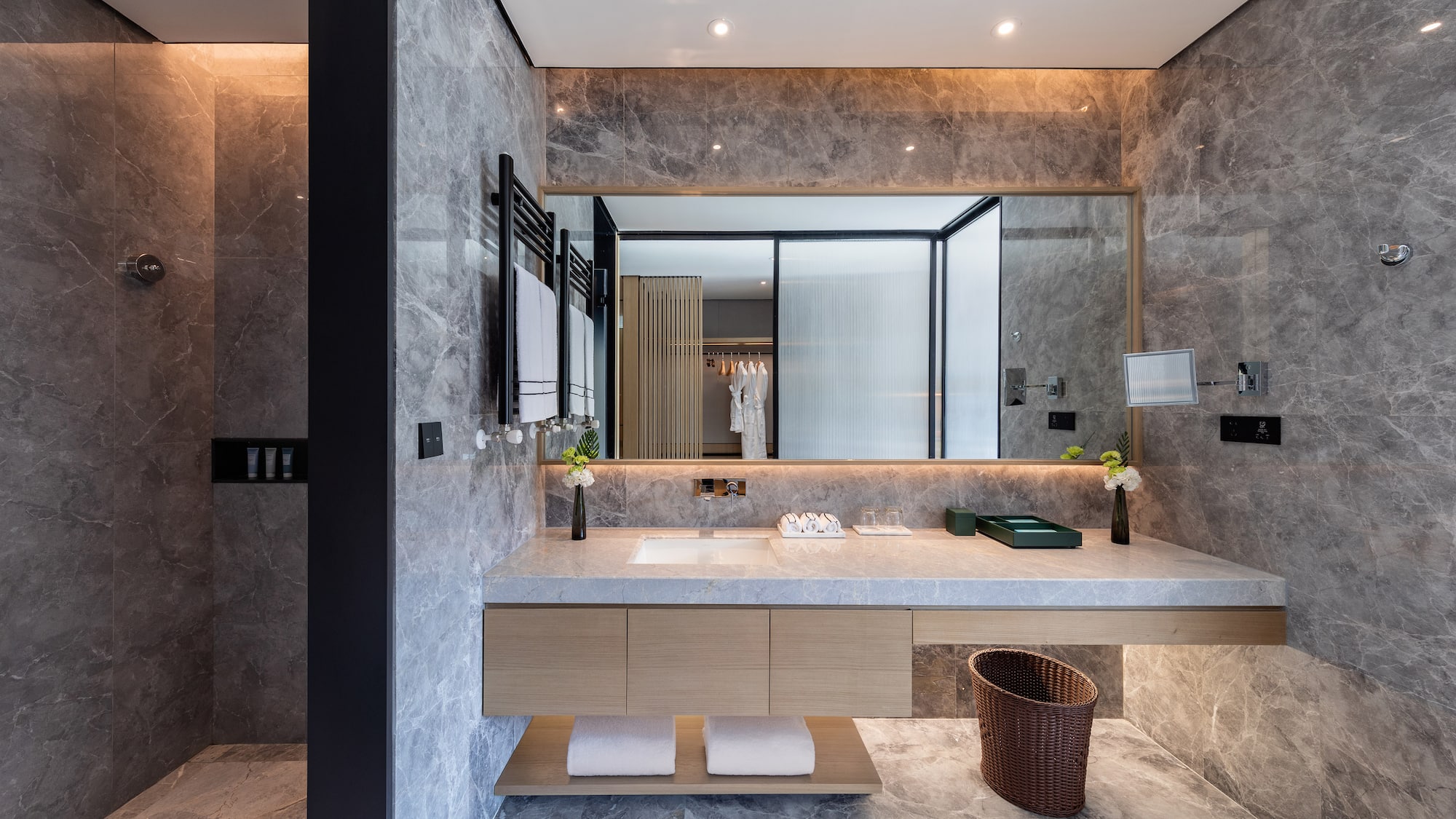 a bathroom with a marble countertop and a large mirror