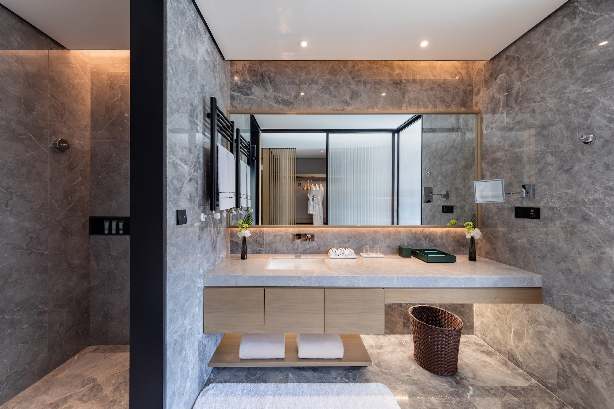 a bathroom with a marble countertop and a large mirror