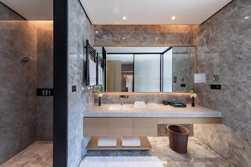 a bathroom with a marble countertop and a large mirror