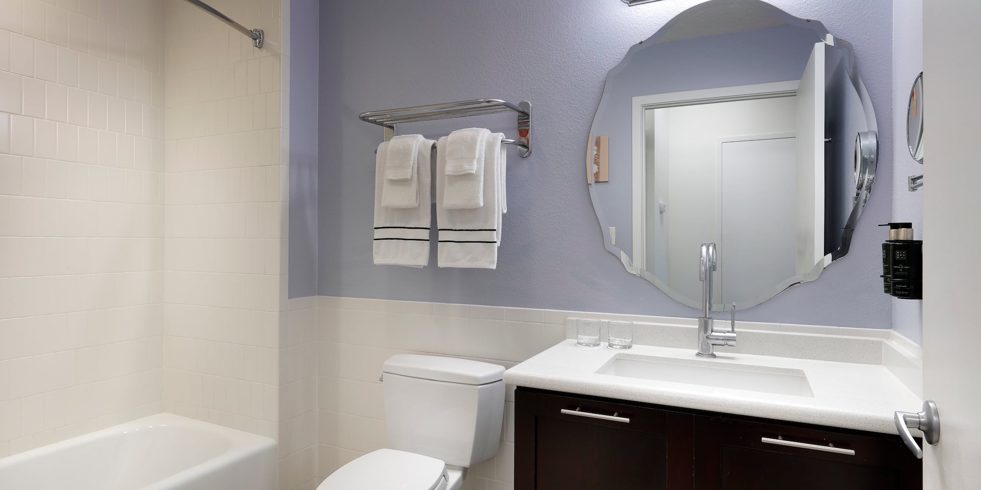 a bathroom with a mirror and a bathtub