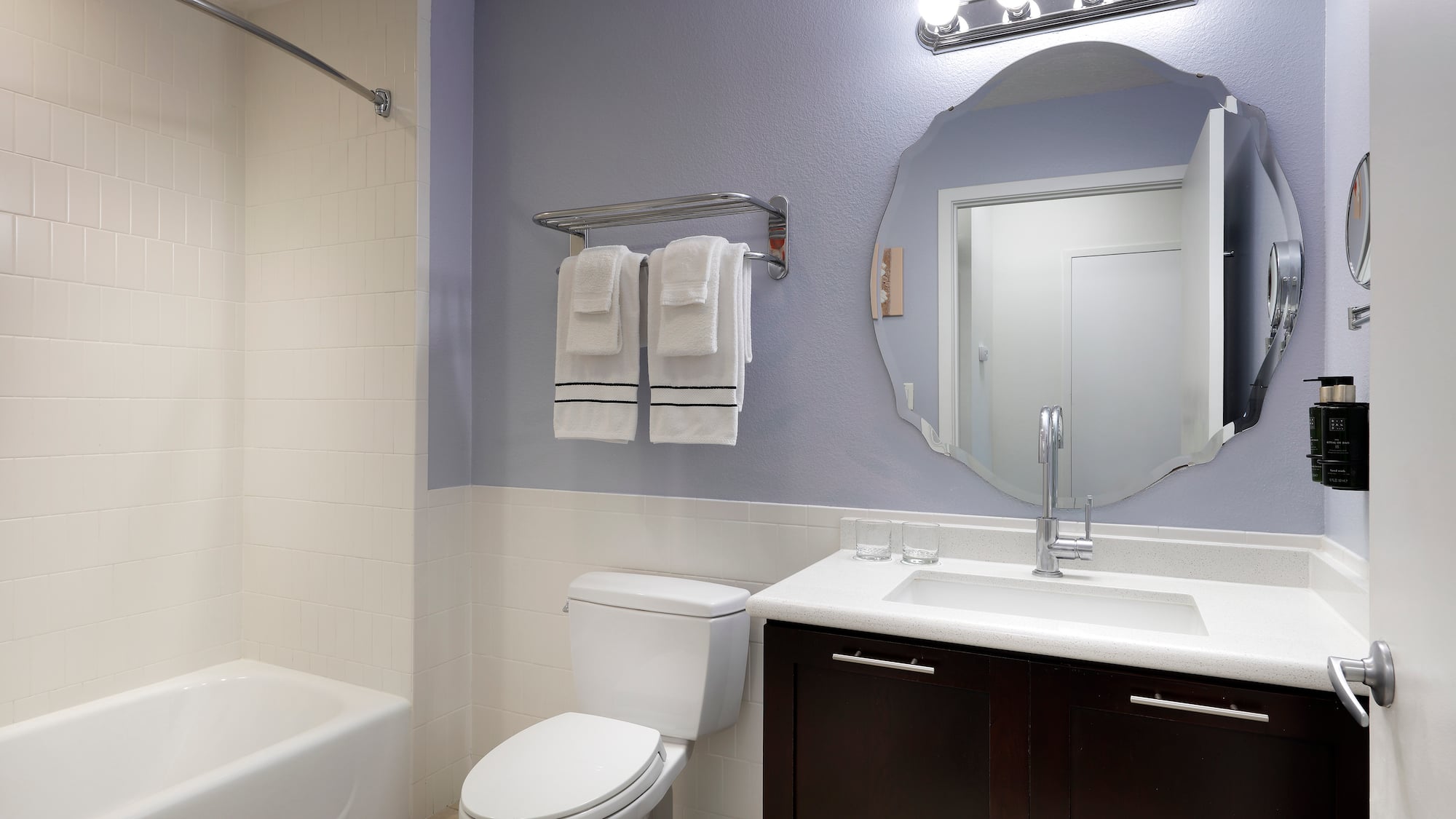 a bathroom with a mirror and a bathtub