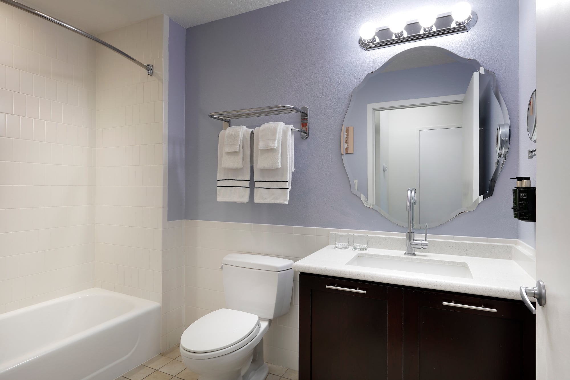 a bathroom with a mirror and a bathtub