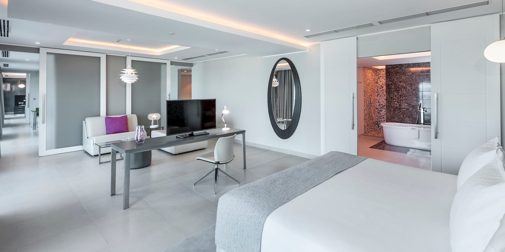 a room with a bed and a television