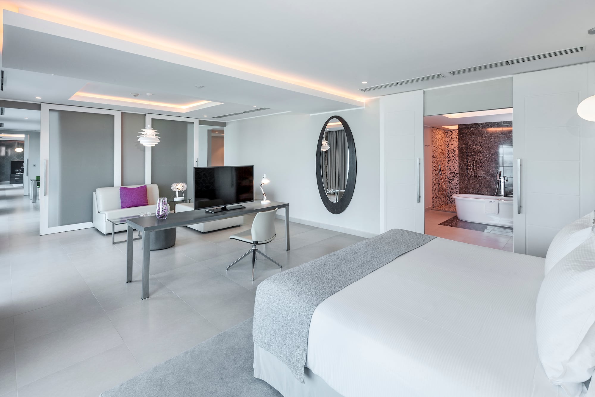 a room with a bed and a television