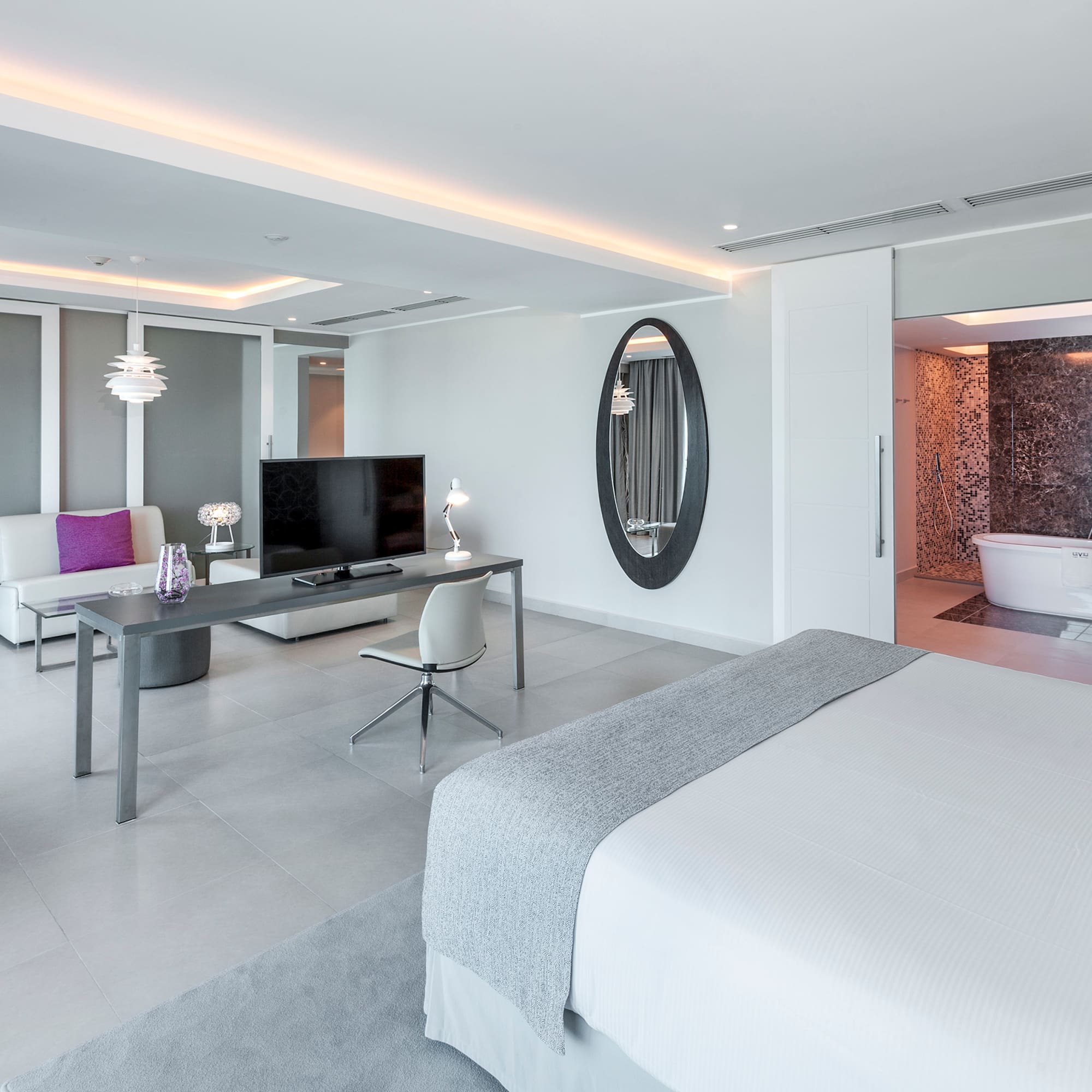 a room with a bed and a television