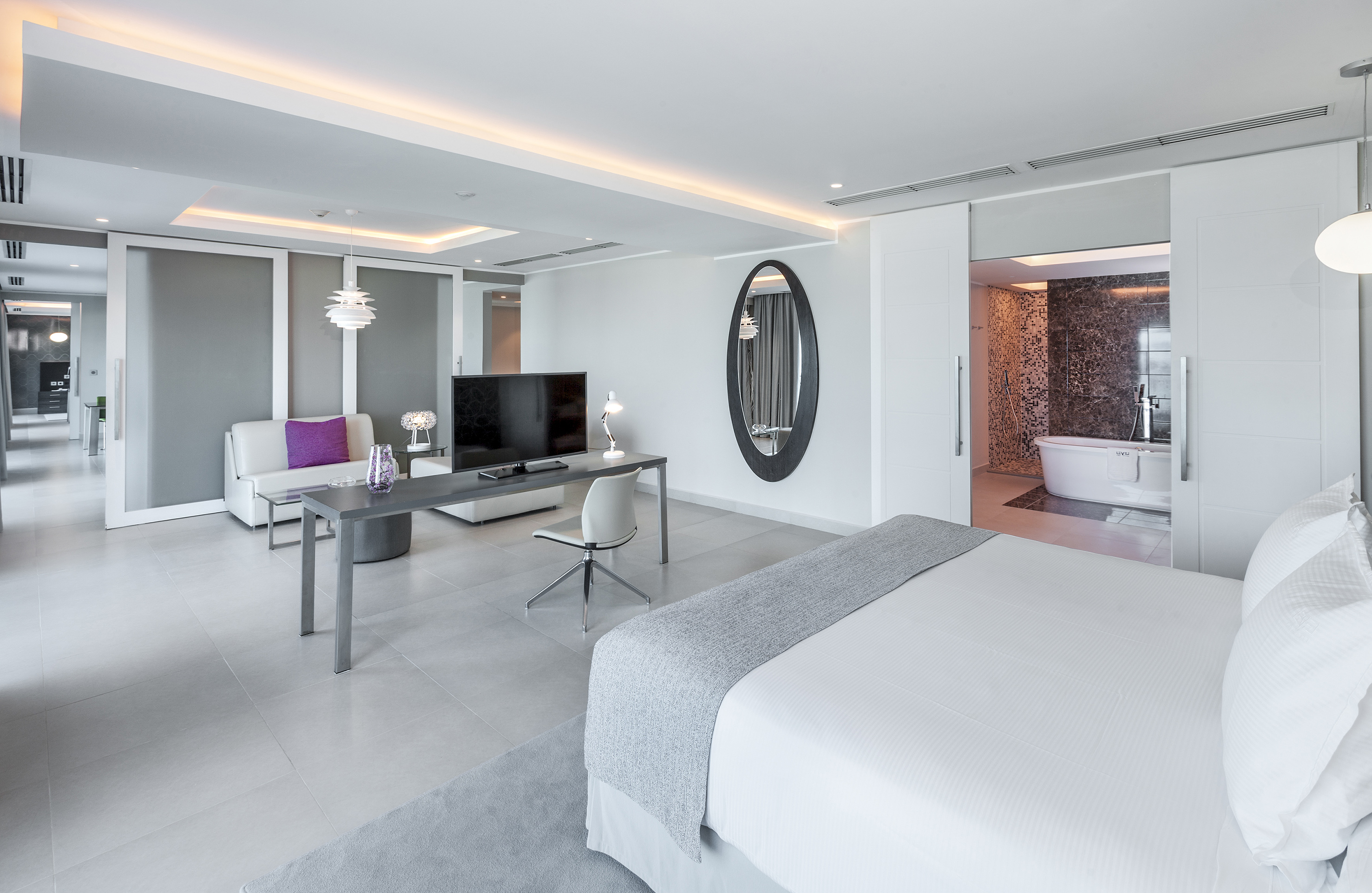 a room with a bed and a television