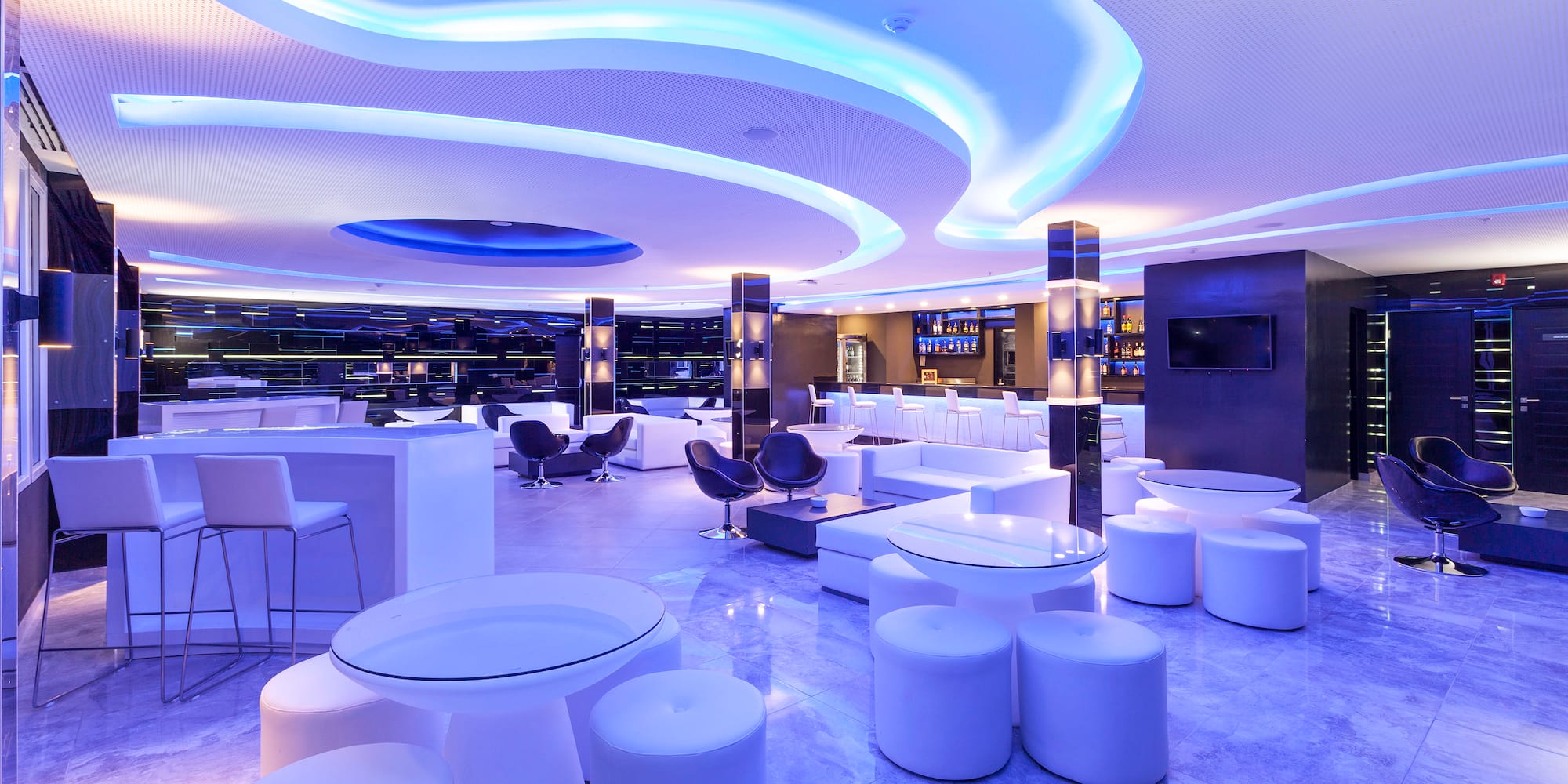 a room with white tables and chairs