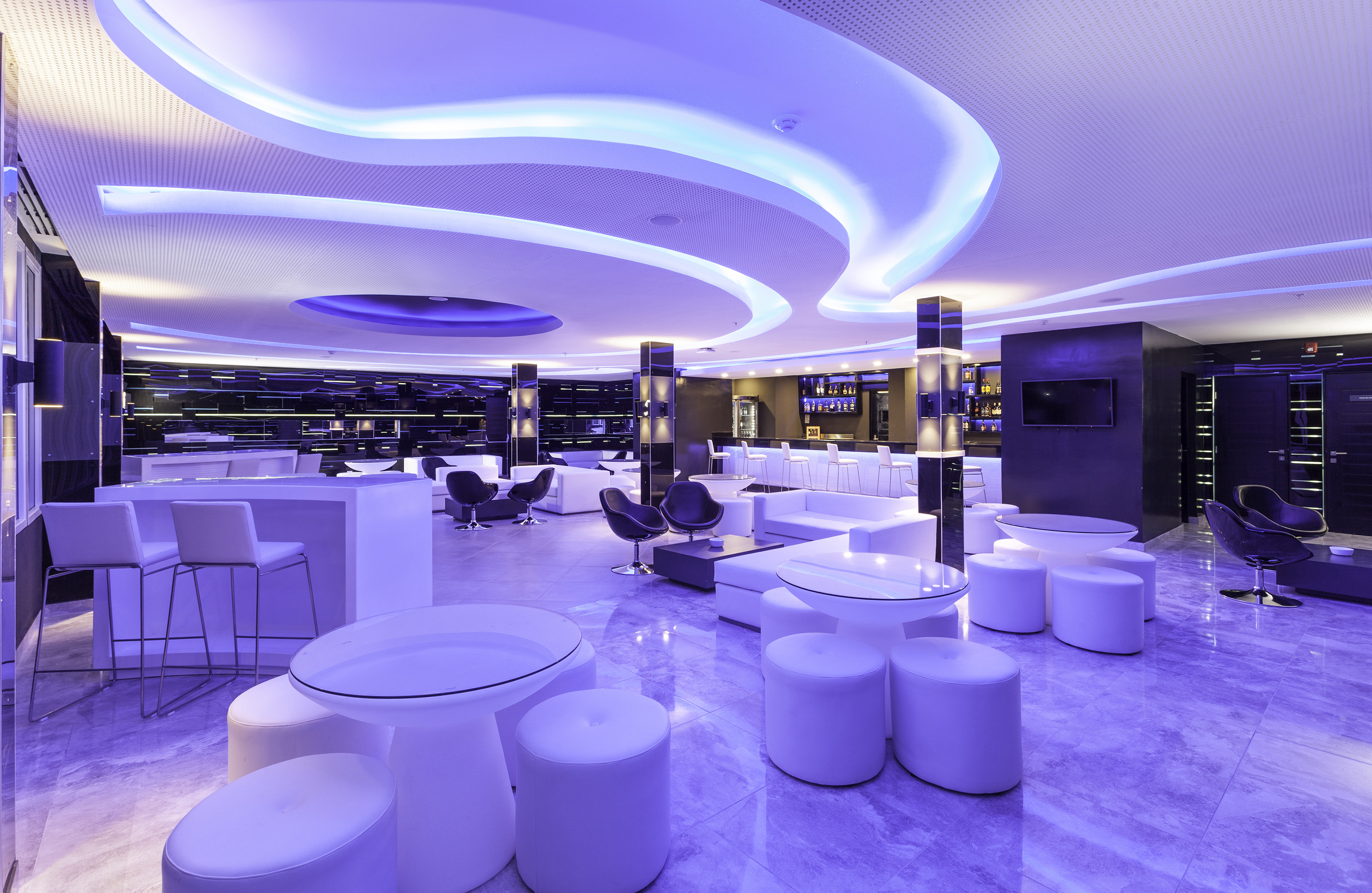 a room with white tables and chairs