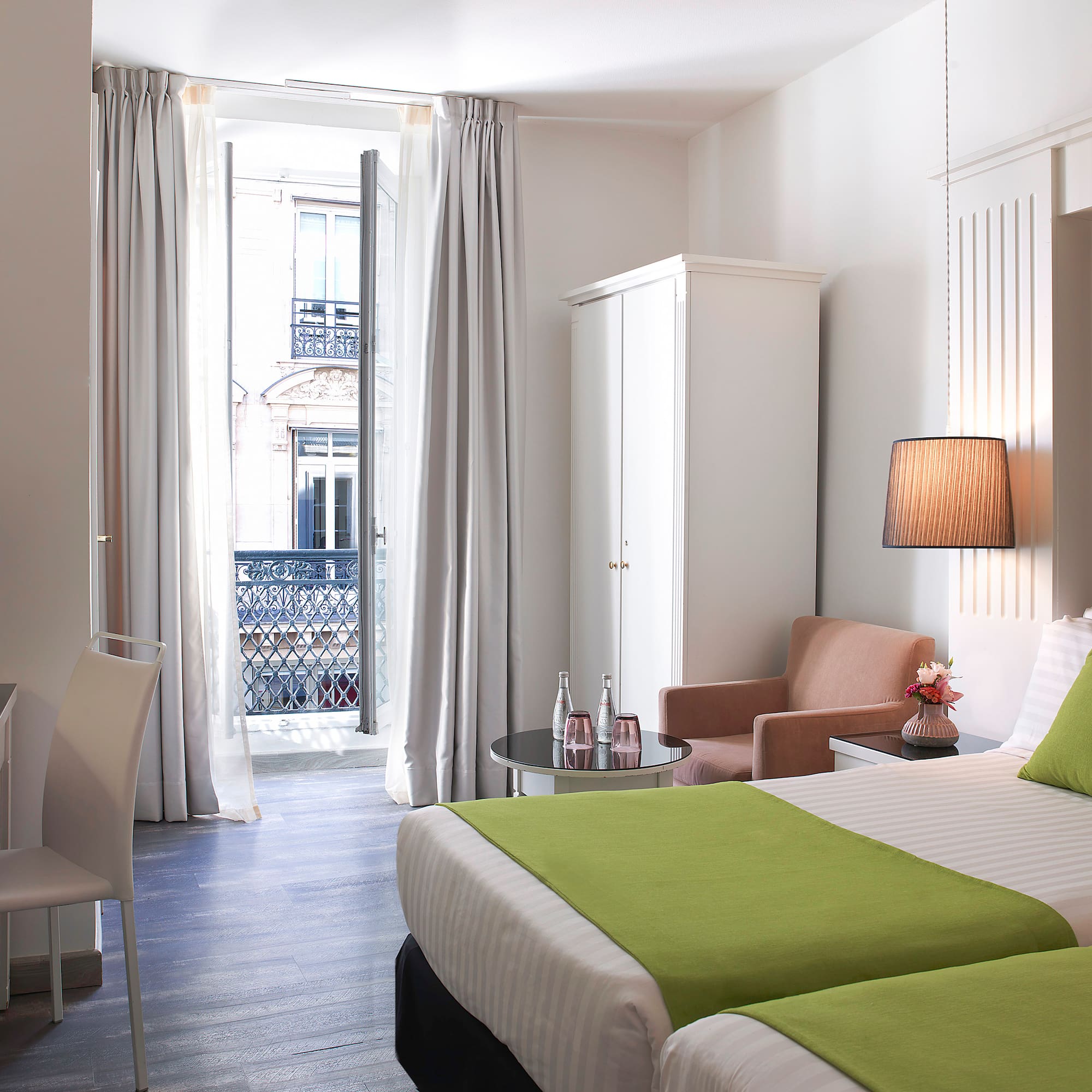 a room with two beds and a table