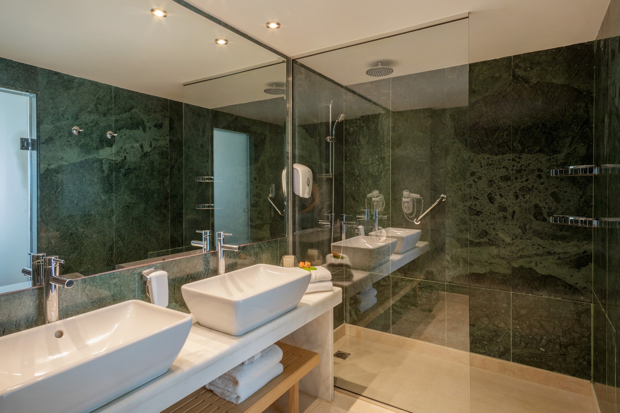 a bathroom with sinks and glass shower doors