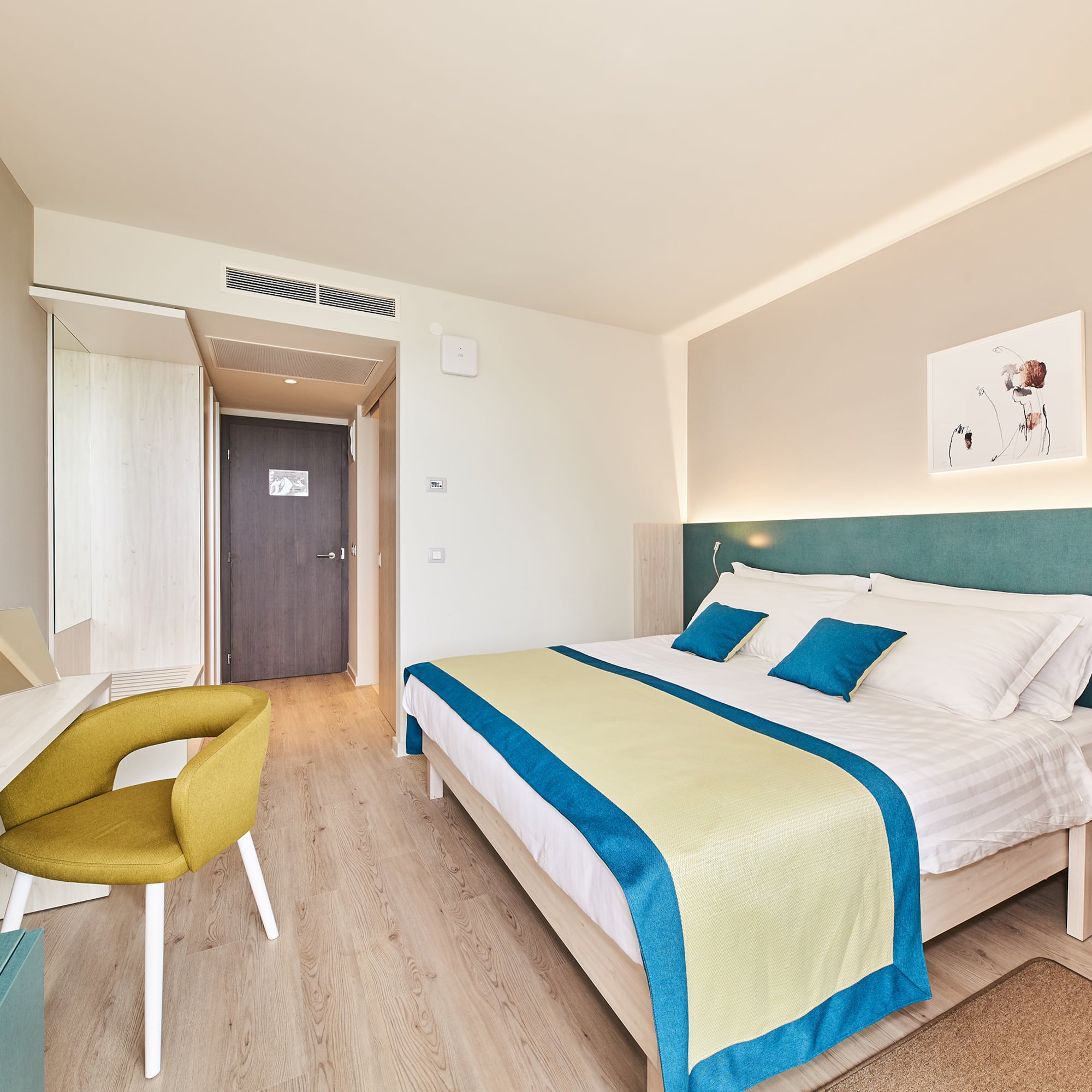 a bedroom with a bed and a desk