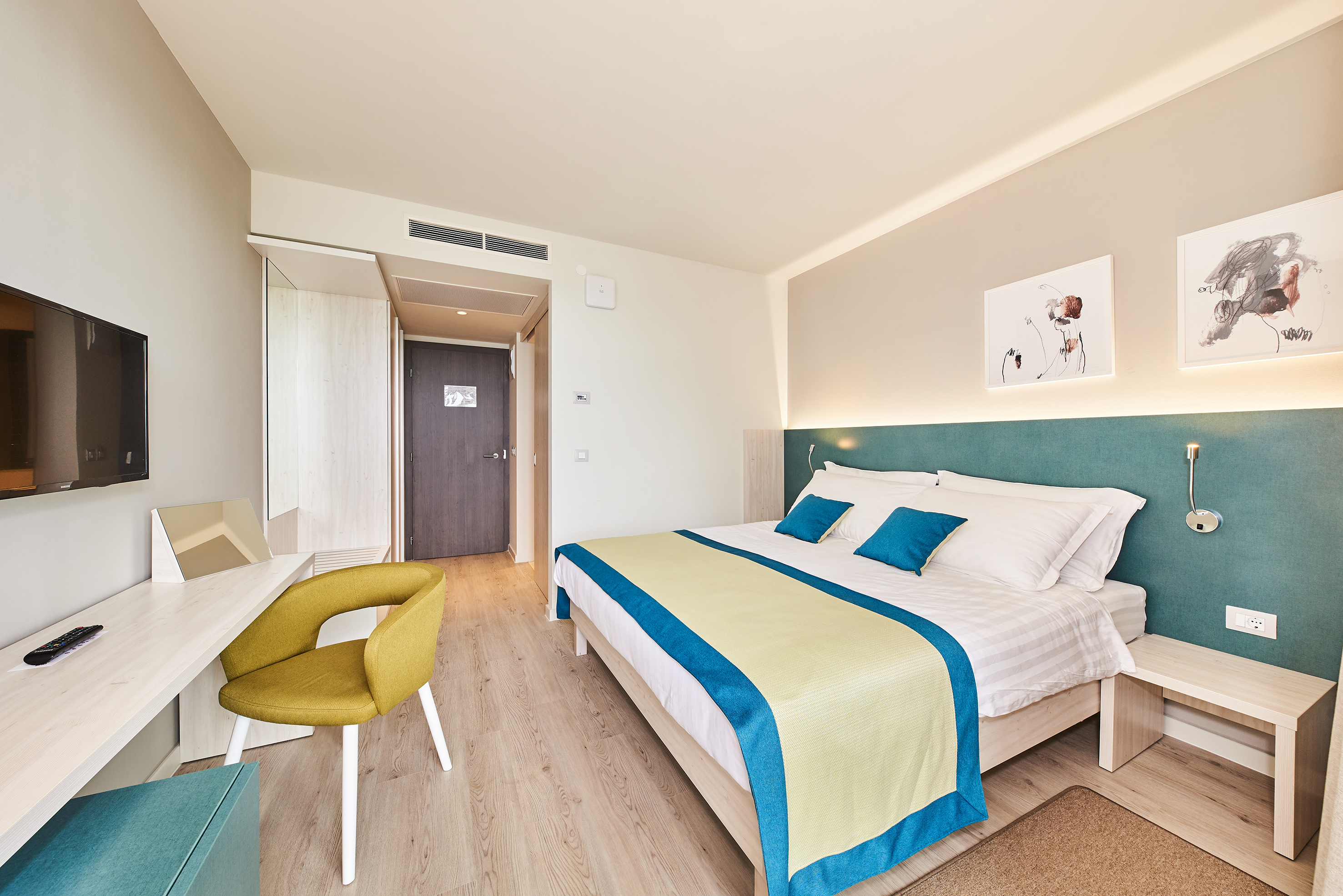 a bedroom with a bed and a desk