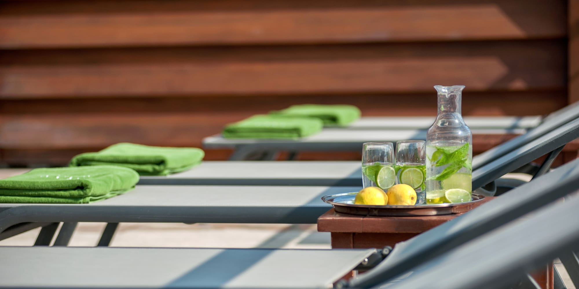 a table with chairs and a plate of lemons and glasses