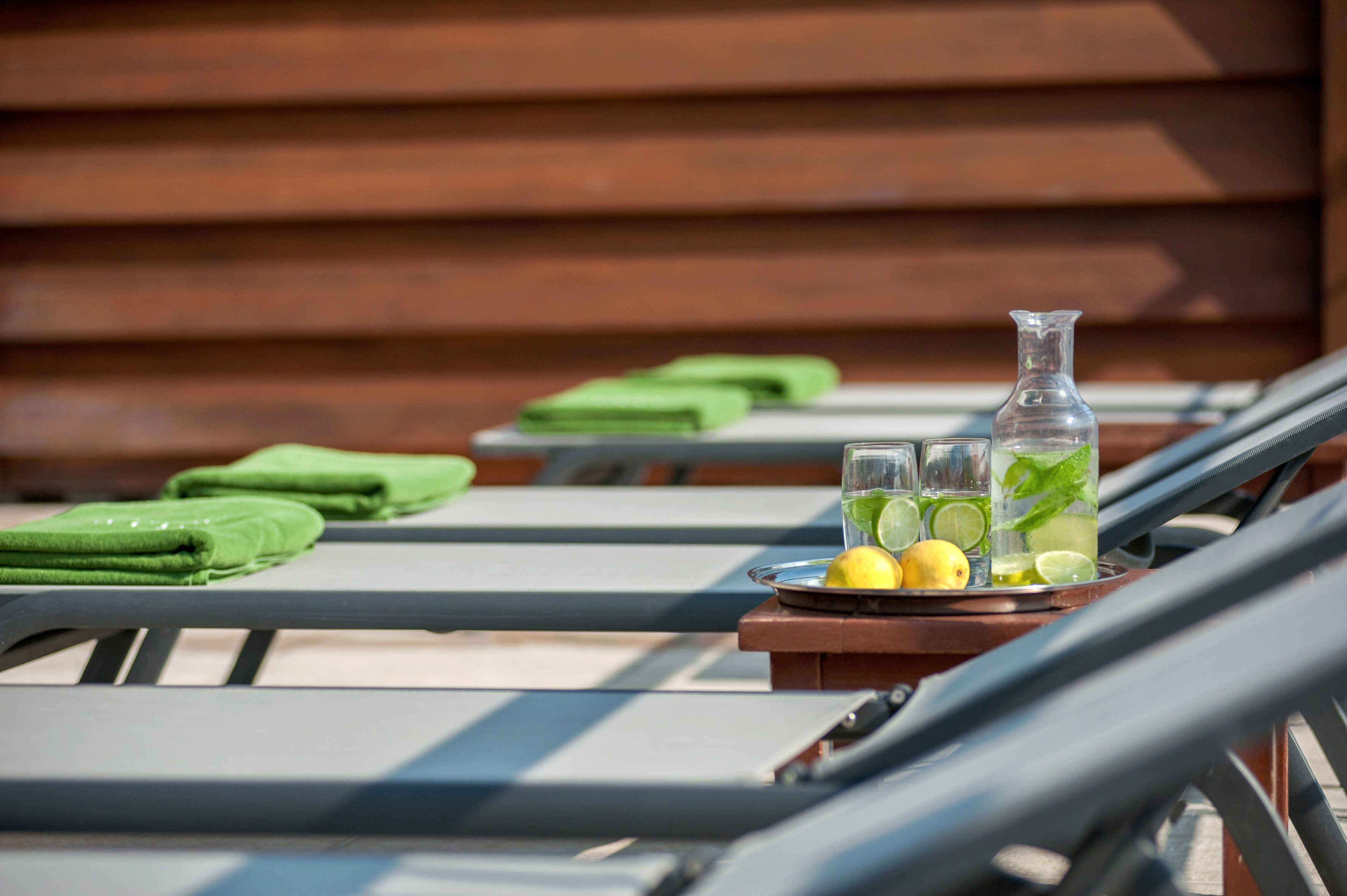 a table with chairs and a plate of lemons and glasses