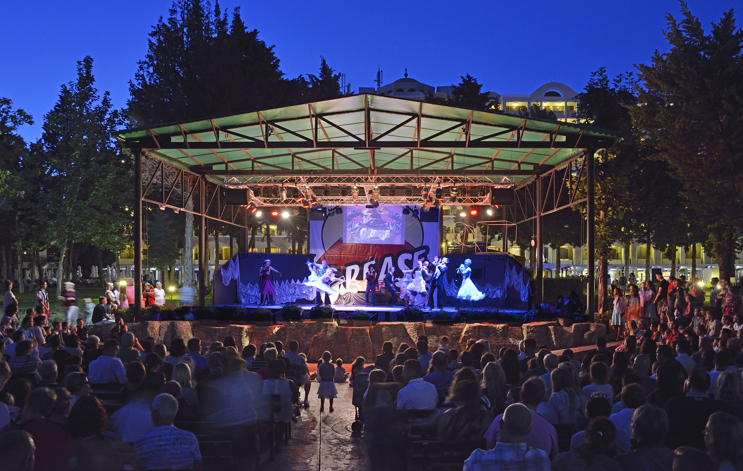 a group of people sitting in front of a stage
