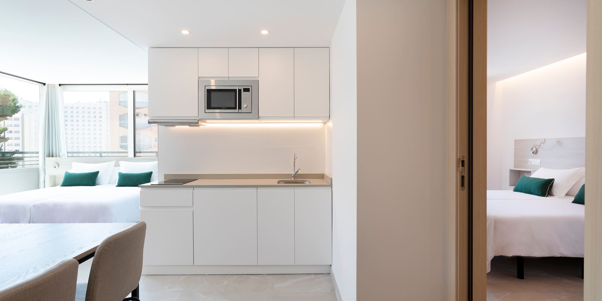 a room with a kitchen and a bed