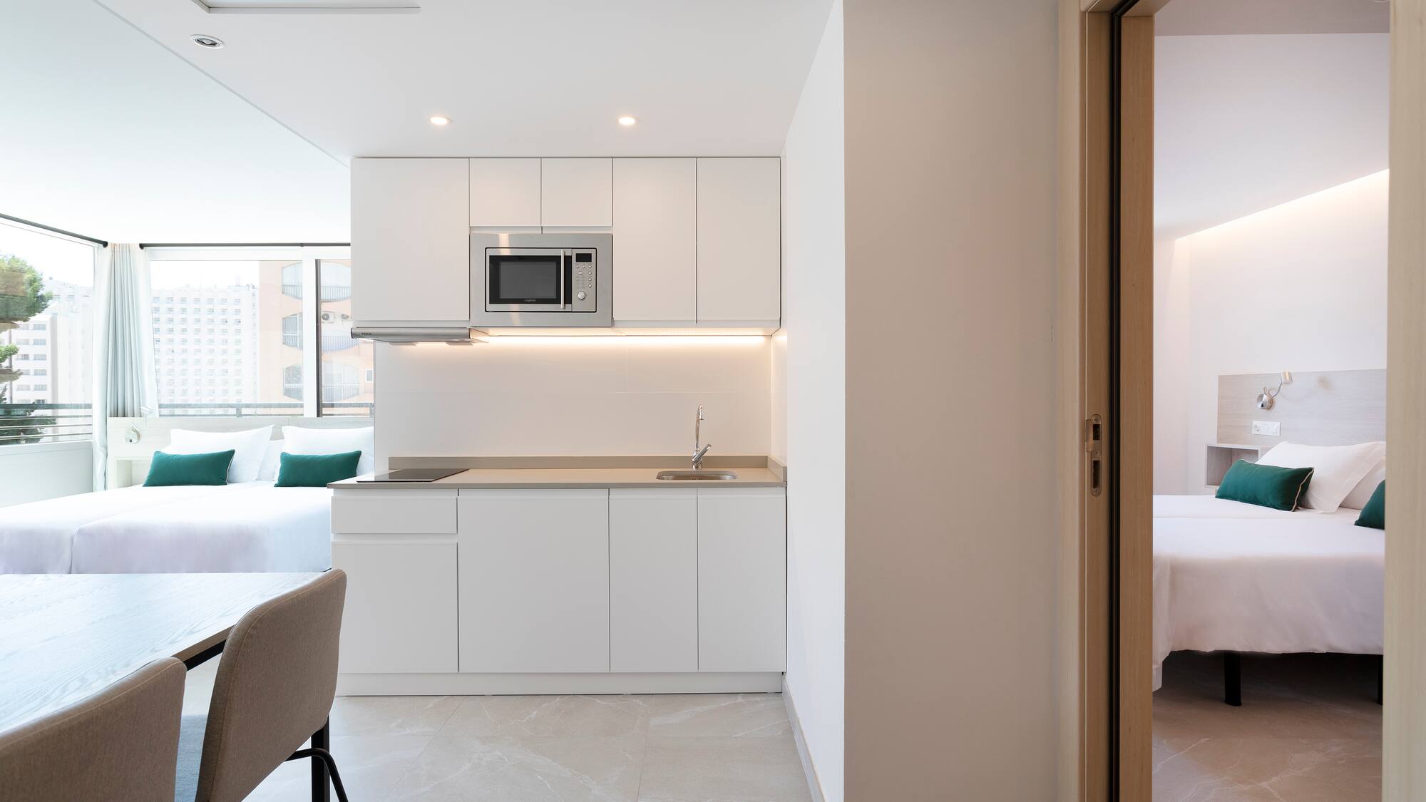 a room with a kitchen and a bed