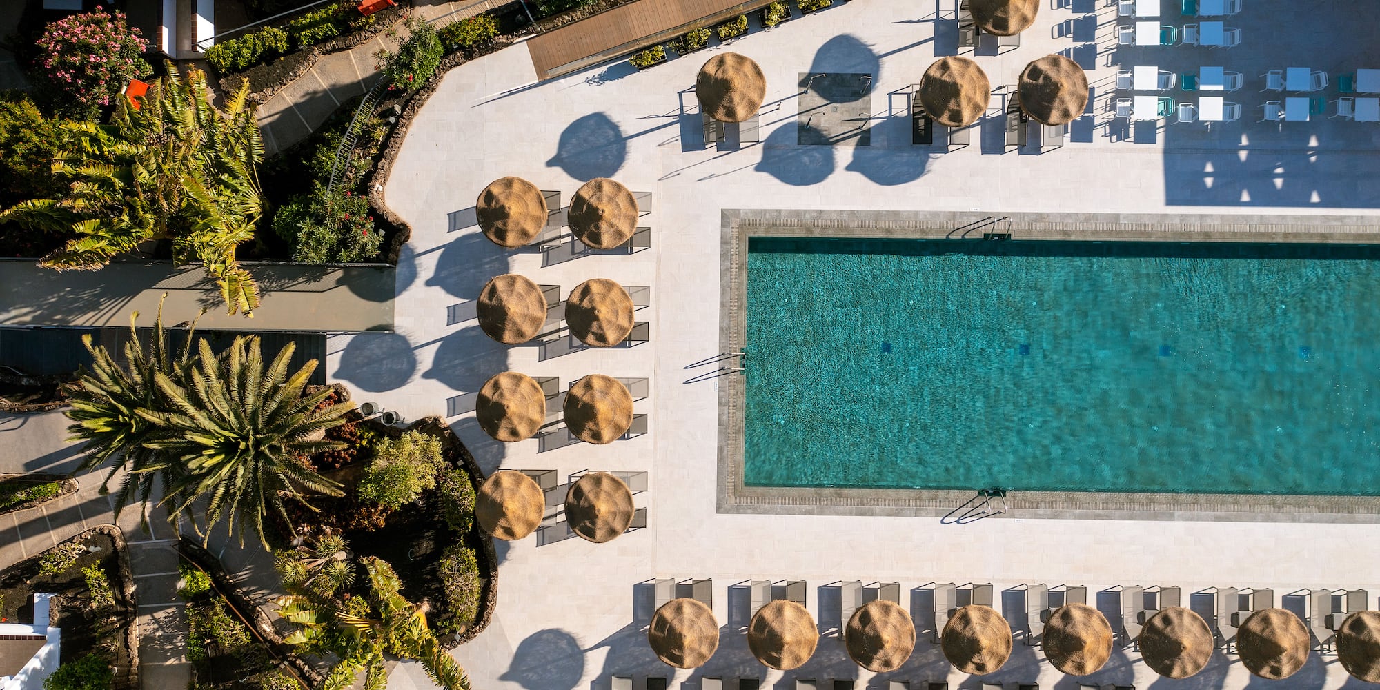 a pool with umbrellas and chairs