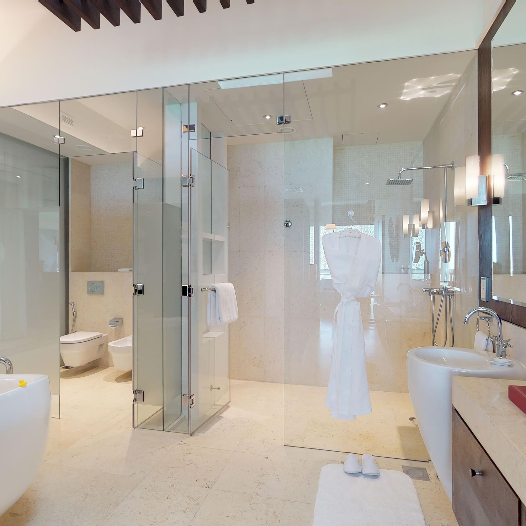 a bathroom with glass doors and a bathtub