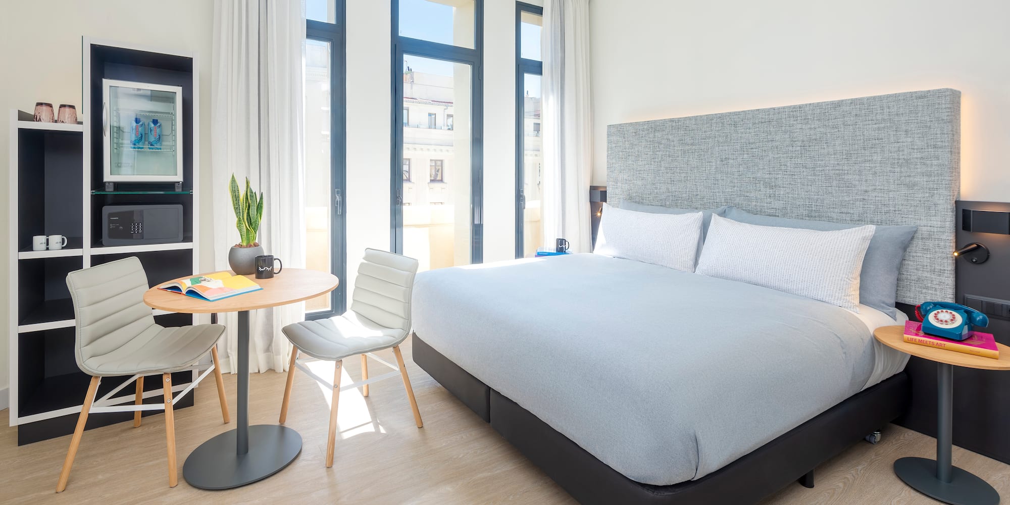 a bedroom with a bed and a table