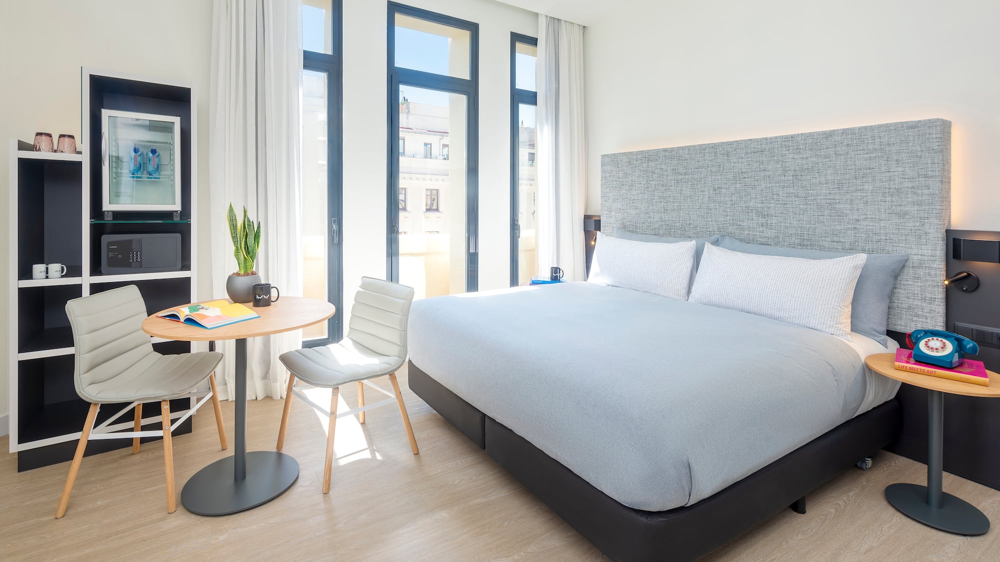 a bedroom with a bed and a table