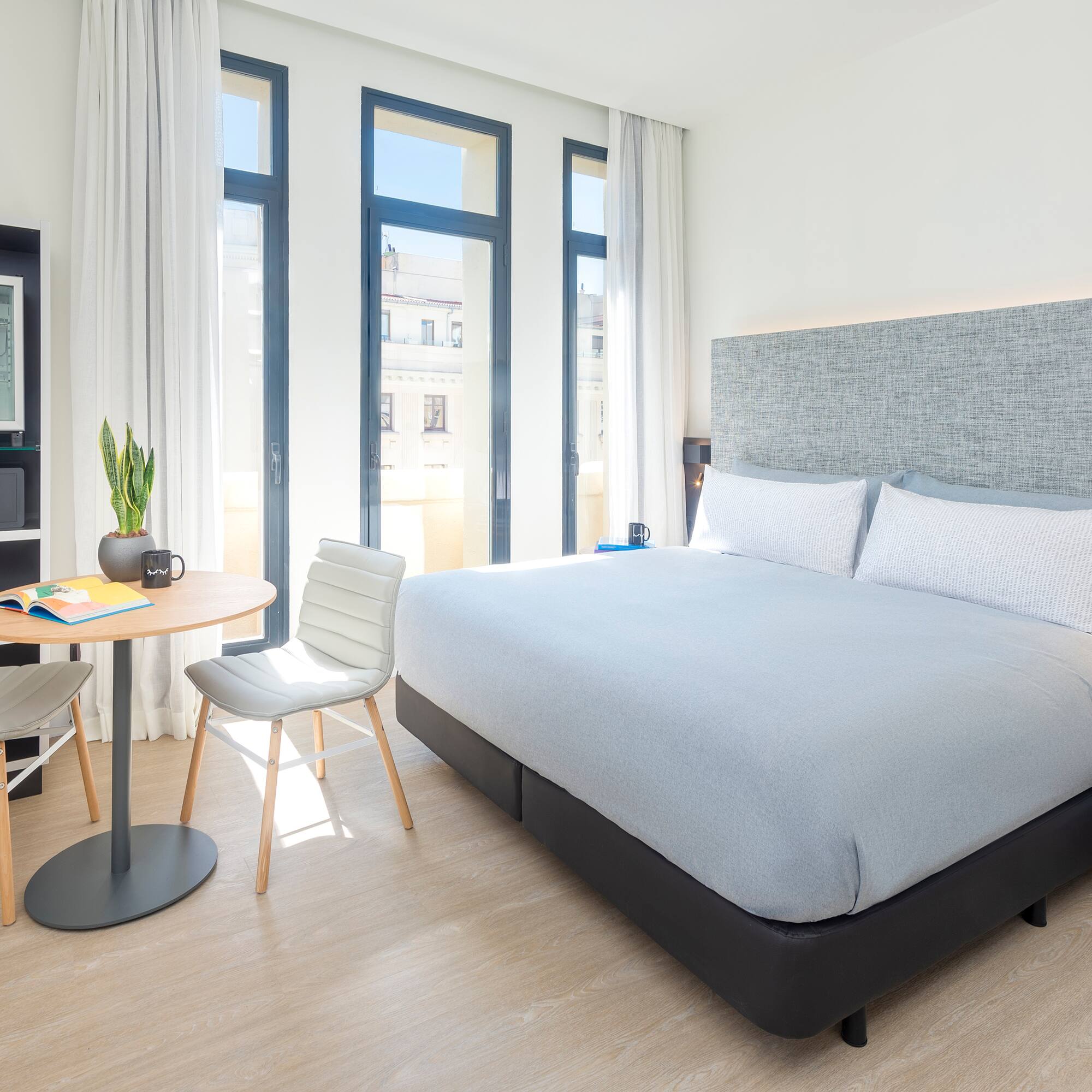 a bedroom with a bed and a table