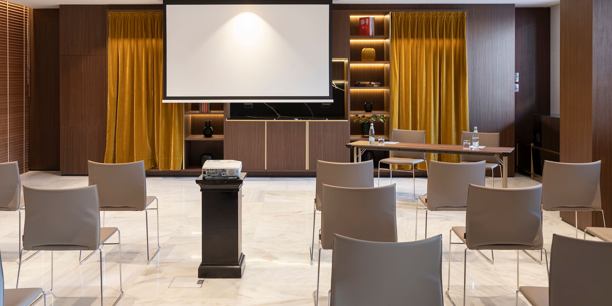 a room with a projector screen and chairs