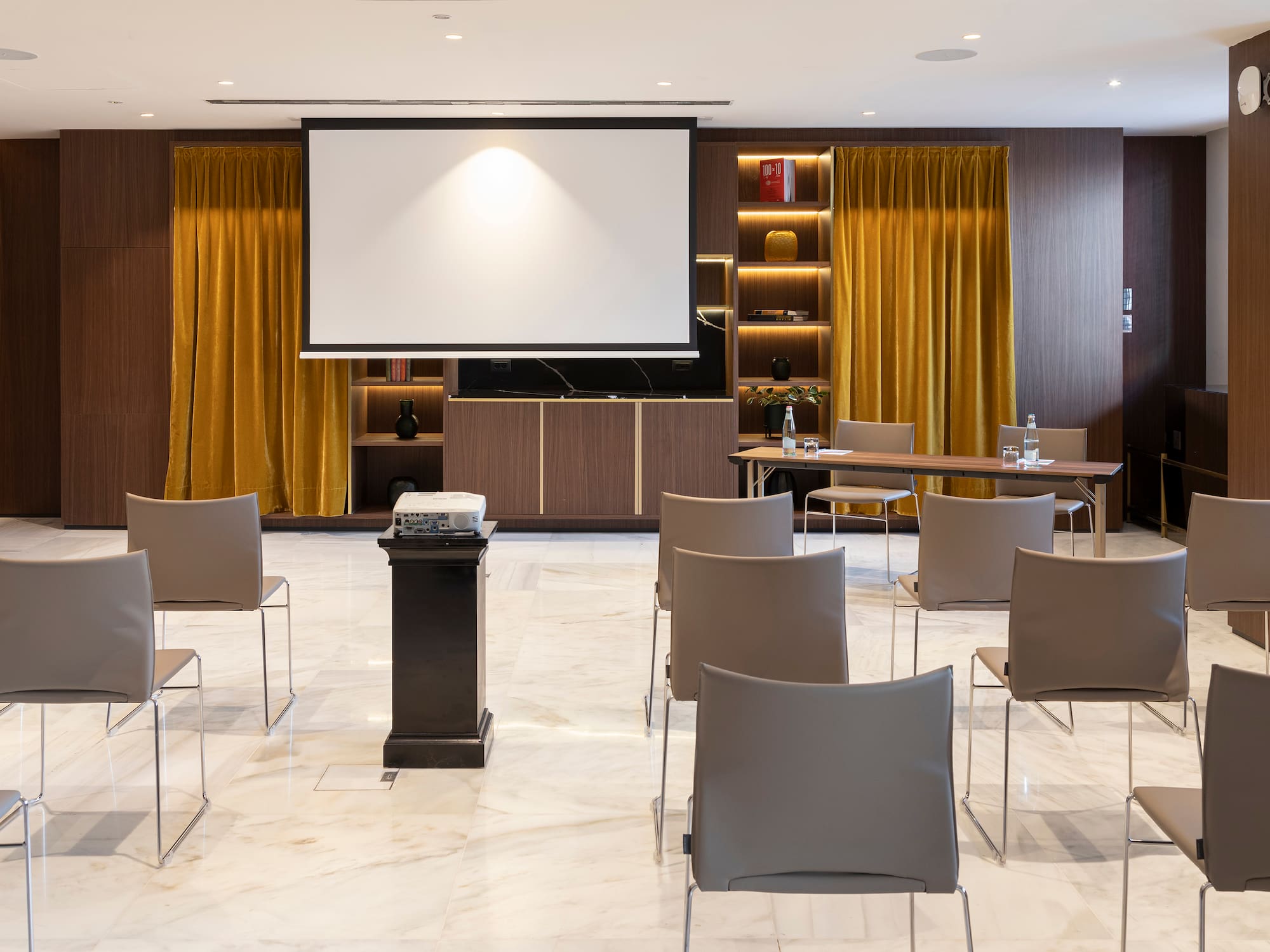 a room with a projector screen and chairs