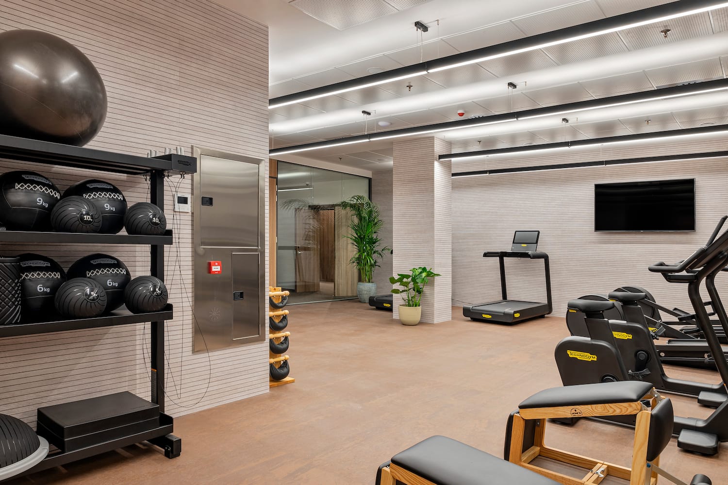 a room with exercise equipment and a mirror