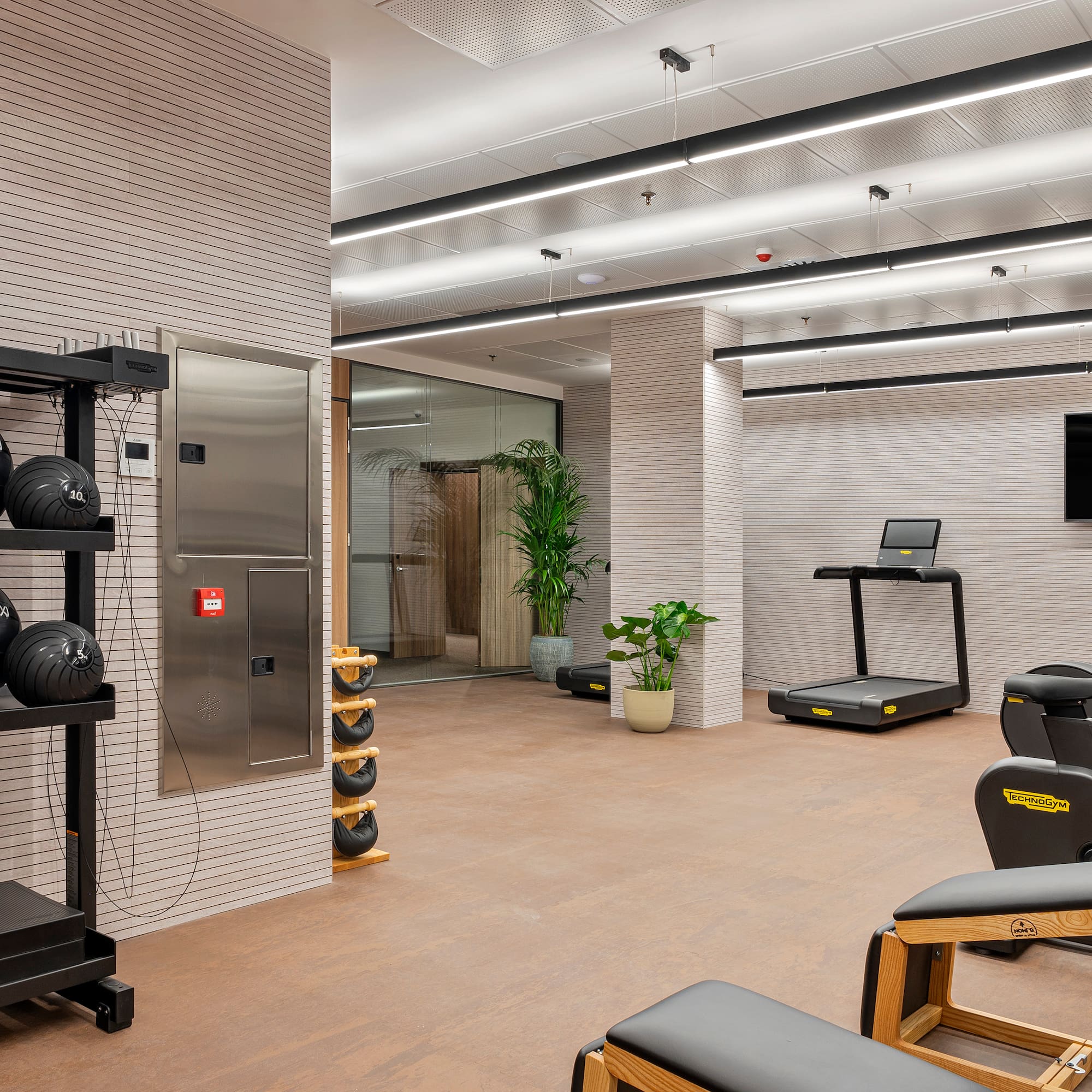 a room with exercise equipment and a mirror
